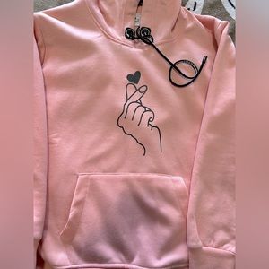 Its a warm hoddie type jacket which is small in size and peach in colour